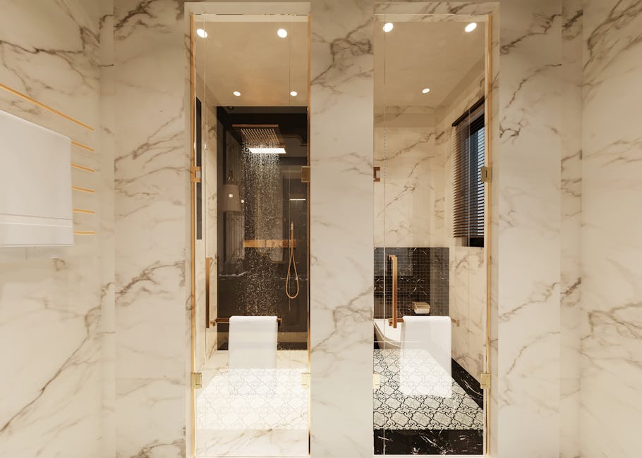A marble bathroom with a glass rain-shower enclosure, brass fittings and patterned encaustic floor tiles.